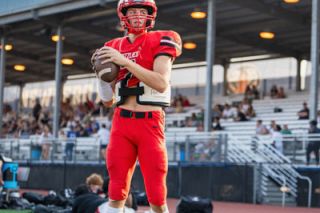 Brandon Bomberger/For the News-Register##McMinnville quarterback Kane Sullivan scored the Grizzlies’ lone touchdown in the 35-7 Lake Oswego defeat. Mac goes on the road again to face Newberg in the Pacific Conference opener.