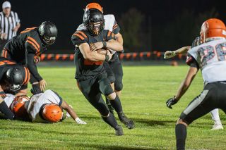 Rusty Rae/News-Register##Willamina running back Jacob Hadley wraps up the ball as he breaks through a hole in the line during Thursday’s game with Culver. Willamina won the contest 69-50 and Hadley scored all but one touchdown for the winner and had more than 400 yards of rushing.