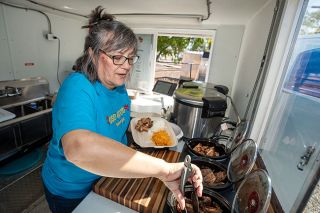 Rachel Thompson/News-Register##Donna Libemday prepares a meal at OSO Good Island Grill, the new food truck she and her husband opened to share the food of their homeland, Micronesia. The truck is open Tuesday, Wednesday, Friday and Saturday near the McMinnville Post Office.