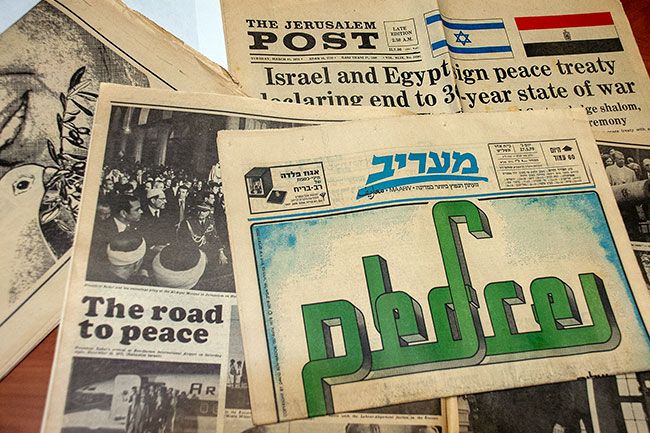 Kirby Neumann-Rea/News-Register##Israeli newspapers from March-April 1979, including page one of Maariv with the word “Peace” interwoven in Hebrew, Arabic and English.