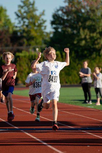 Rachel Thompson/News-Register: Joshua Woodsworth, pictured here triumphantly raising his arms, was the winner of the boys race at Runtoberfest 2023.