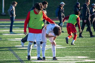 Tanner Russ/News-Register##McMinnville players comfort one another after the loss to Cleveland. The Warriors scored the go-ahead goal with two seconds remaining in the game.