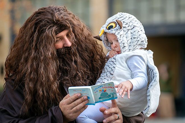 Rachel Thompson/News-Register file photo##During last year s trick-or-treating on THird Street, Kyle Kratzer as Hagrid reads a book with son Kayden as Hedwig the Owl from Harry Potter. Yamhill Community Care early childhood programs gave out hundreds of books on Third Street.