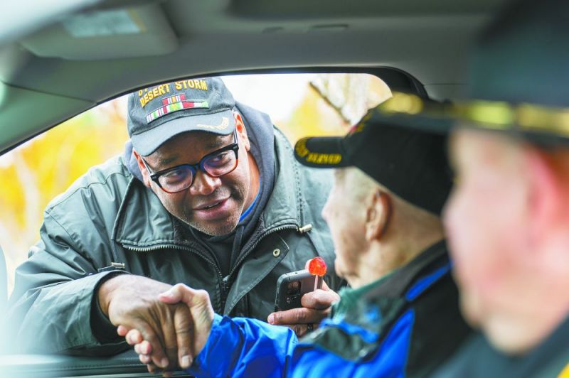 Rachel Thompson/News-Register##Desert Storm veteran Steve Smith, who works at the Veterans Administration Hospital in Portland, thanks World War II veteran Byron Garoutte for his service. Garoutte, who lives in Newberg, rode as grand marshal in the McMinnville parade.