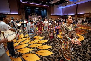 Rachel Thompson/News-Register##The honorary Canoe Family, comprised of children and adults, dances Sunday as part of the Confederated Tribes of Grand Ronde’s 40th Restoration Celebration at Spirit Mountain Casino Events Center.