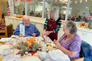 News-Register file photo##Starla Pointer/News-Register
Volunteer Kareen LaValley covers a slice of pie with whipped cream for diners Louise Harper, right, and Chuck Ludwig at the 2023 event hosted by Friends of the Senior Center.
