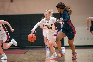 Rusty Rae/News-Register##McMinnville senior Peyton Justice runs a fastbreak against Westview freshman Dara Oluwafemi in the Grizzlies’ first home win of the season.