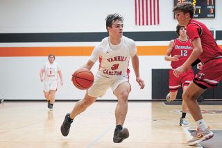 Rusty Rae/News-Register##Yamhill Carlton senior Kyle Slater hit the clutch, game-sealing shot with five seconds to go in overtime against the visiting Tillamook Cheesemakers. Slater finished the night with 29 points.