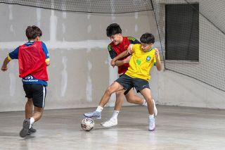 Rusty Rae/News-Register##(black Mexico shirt with red pennie) Emmanuel Mendoza and (yellow Brazilian shirt) Alexander Garcia battle for possession of the futsal ball.