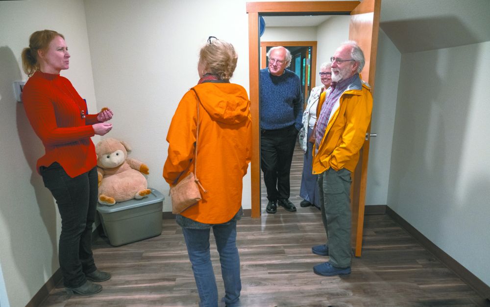 Rusty Rae/News-Register##Kaye Sawyer, left, co-founder of the Yamhill  County Gospel Rescue Mission, greets visitors during the Dec. 27 open house at the expanded facility at 14th and Logan serving unhoused men, women and families. The mission recently expanded its dorms and added private family rooms, a nursery, playrooms, other gathering areas and  a modern kitchen. With Sawyer are Eric and Annie Witherspoon, center and right, of Yamhill, and board member Craig Thornton and wife, Becky, in the doorway.