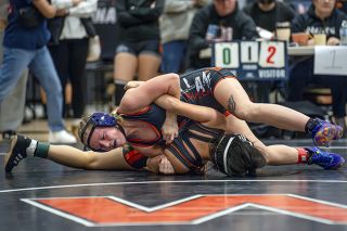 Rachel Thompson/News-Register##Willamina’s Zoe Brewer (top) won all of her matches to take first in the 110-pound girls wrestling bracket at the Bob Bishop Invitational.