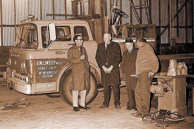 ##(Jan. 8, 1969) Getting a warm welcome to McMinnville this week during one of the area’s recent arctic periods were officials of the E.W. Lindsey Mfg. Co., Hemet, CaIif., who were directing the establishment of a new woodworking plant in this community. Mr. Phillip Lehman, left, president of the company, discusses plans with A.T. (Pete) Beall, manager of the McMinnville Chamber of Commerce, and C.E. Colvin, a director of McMinnville Industrial Promotions. H.M. (Doc) Evans, right, will be manager of the company’s McMinnville plant, which is expected to employ about 12 people in construction of roof trusses for the mobile home industry. Equipment was installed this week in a building owned by Bud Wittrock at 820 E. First. [Now the Boho Building]