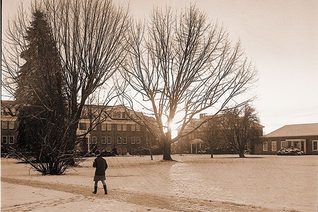 ##(Jan. 15, 1969) Sun peeked through Linfield campus while a student strode to her classes in the early morning light Monday after a two-inch snowfall.