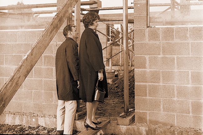 ##(Jan. 18, 1969) Mr. and Mrs. Norm Coffelt of McMinnvilIe look into future building which will house Norm’s Mini-Mart grocery store on Three Mile Lane near Atlantic Street. Coffelts plan to open the store about Feb. 1, and will be a family-run operation.