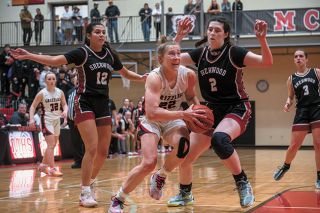 Rusty Rae/News-Register file photo##McMinnville’s Macie Arzner drives past Sherwood’s Ava Heiden (2) in first of two regular season meetings. The duo went on to win Pacific Conference Co-Players of the Year.