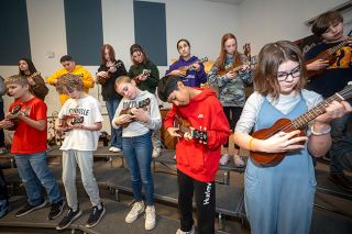 Rachel Thompson/News-Register##Sixth-graders strum to a Santana song in Duniway’s ukulele class. “It’s a really good song,” said Leo Gonzales, in red second from right.