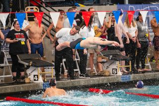 Rusty Rae/News-Register##McMinnville’s 200-yard freestyle relay team took fourth place in the state finals at Tualatin Hills Recreation Center on Saturday, Feb. 24 with a time of 1:35.13. Jace Zemlicka, pictured here diving into the pool, was the third leg of the team.
