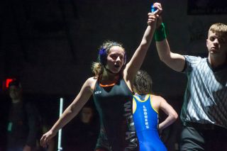 Tanner Russ/News-Register##Willamina’s Zoe Brewer gets her hand raised after her district championship victory.