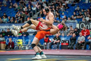 Rachel Thompson/News-Register##WIllamina’s Kisor Savage hoists Lowell’s Harley Hardison in the air during his championship match at the 2A/1A state championship meet at Veterans Memorial Coliseum.