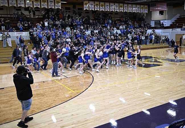 Rusty Rae/News-Register##Amity students rush the court after the girls basketball team defeats Sutherlin.