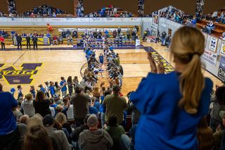 Rusty Rae/News-Register##Amity community members formed an ever-growing tunnel for the starting girls basketball players to race through ahead of each game.