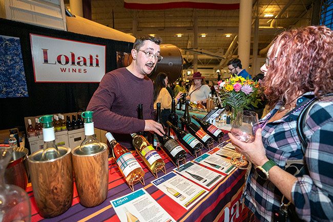 Rachel Thompson/News-Register file photo##At the 2024 Wine & Food Classic, Marcus Glaze, left, of McMinnville talks wines from Lolati Wines with Theresa Richmond-Woods from Portland. Lolati Wines, with roots in South Africa, is based in Sherwood.