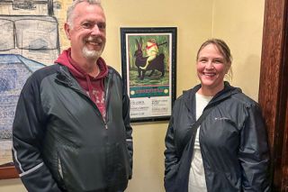 Kirby Neumann-Rea/News-Register##Leap Day frog finders are Mark Keen and Karla Peterson of McMinnville, who visited Hotel Oregon to find the frog on the day s scavenger hunt. Second floor poster advertised an Edgefield concerts including Jimmy Cliff and Indigo Girls. McMenamins celebrates St. Patrick s Day this weekend with stout, music and dancing.