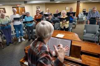 Rusty Rae/News-Register##Led by Marcia Stratman, members of the Hillside Chorus rehearse in the retirement center’s activity room. Singers say they enjoy both the music and the socializing as they prepare to perform songs such as “Side by Side.” The chorus will give a public concert May 7.