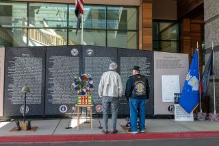 Rusty Rae/News-Register##Robert Lalonde, of Dallas and formerly of McMinnville, and Tom Davis, of Roseburg and the Umpqua Valley Chapter of the Vietnam Veterans of America, talk Saturday at the Evergreen Aviation and Space Museum where the traveling Vietnam Wall visited over the weekend.