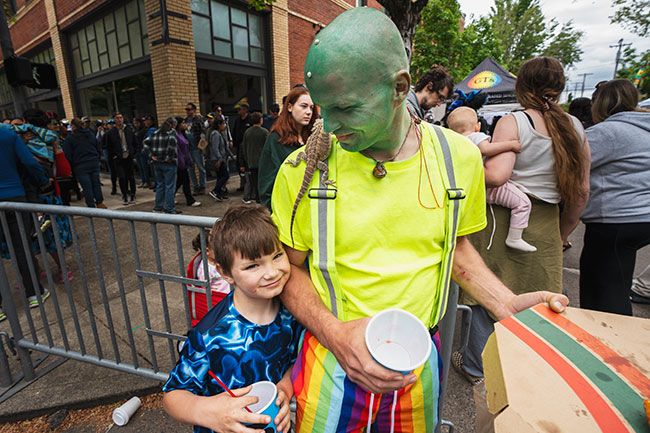 Rachel Thompson/News-Register##Lir Moore, age 7, left, and Rayce Ryan, with Jasper the bearded dragon on his shoulder, take in the human and alien pageantry on Third.