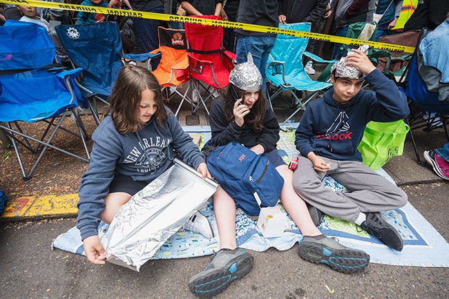 Rachel Thompson/News-Register##McMinnville seventh-graders Riley Dudas, left, Jedidiah Pewonka and Moises Rubio make tinfoil hats before the start of the parade.