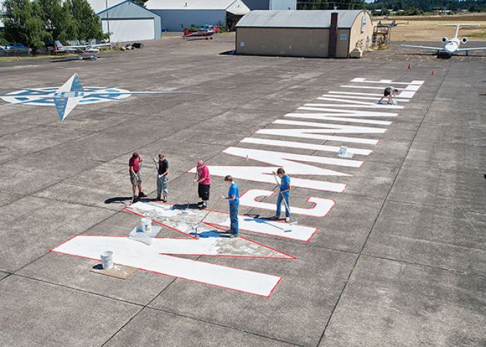 News-Register file photo##Members of Boy Scout Troop 260 repainted the white lettering at the McMinnville Municipal Airport in 2015.