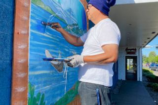 Starla Pointer/News-Register##Painter Juan Melchor prepares to repaint one of the murals outside the Mazatlan restaurant on Highway 99W in north McMinnville. Melchor completed several new scenes of coastal Mexico on the building last week.