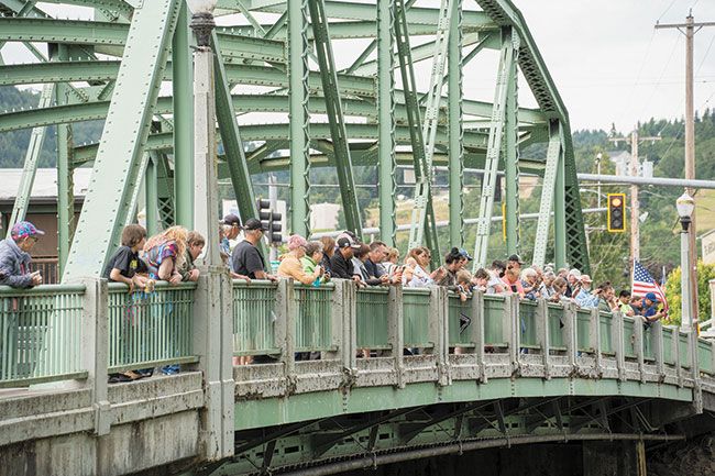Rachel Thompson/News-Register##A crowd lines the bridge to watch the duckies race down South Yamhill River. “This was our inaugural event,” said Rotary Club President Ian Coker of the duckie races. Rotarians had held the races some 35-50 years ago, according to Rotarian Brad Myers, a member of 35 years.