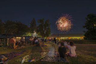 News-Register file photo##Dayton community members turn out for the town’s first fireworks display last year, a 10-minute show that exploded a variety of pyrotechnics behind the Dayton Elementary School building .