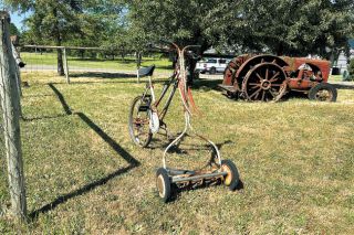 Kirby Neumann-Rea/News-Register##Someone put together a bicycle frame and person-powered lawn mower and parked it on a Riverside Drive lawn.