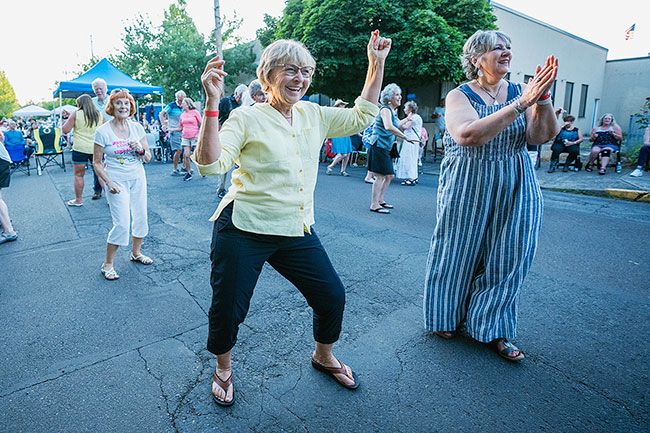 Rachel Thompson/News-Register##Debbie Hakala of Dayton, left, and Angela Espinosa of McMinnville, right, and others have a great time dancing on Fourth Street during the Firefighter’s Dance, a Turkey Rama tradition that made its return Friday in downtown McMinnville. The McMinnville Fire Department and McMinnville City Club organized the dance and dinner, with plans to offer more Turkey Rama activities in 2025. “The community really showed up and the nostalgic vibes were strong,” said Chelsey Nichol of the City Club.