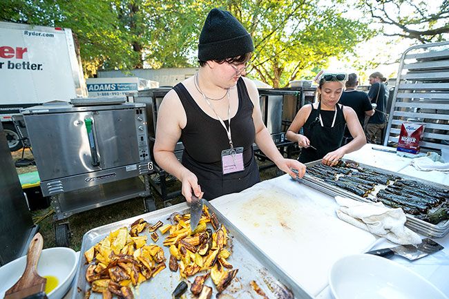 Rachel Thompson/News-Register##Caden Fremming, left and Julia Holloman, prepare grilled eggplant with za’atar, greens and fresh chickpeas, a dish by Chef Paul Losch of Ruddick/Wood in Newberg, for the IPNC grand dinner. Fremming and Holloman are students at Edmonds College Culinary Arts program in Edmonds, Washington. Their instructor, one of the managers at the Grand Dinner, recommended them and a few other students for back of house work. Seminars, tastings and meals were held on campus and at wineries and restaurants around Yamhill County.