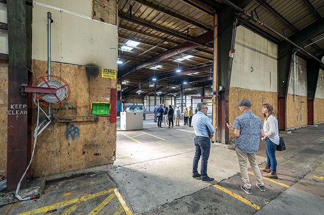 Rachel Thompson/News-Register##In August, city consultant Chris Zahas, left, speaks with Jake Lewis, center, and Amber Swanson, architects from Salazar Architect in Portland, during the Ultimate RB plant tour.