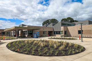 Newberg School District photo##Oval planting areas grace the front of the new Dundee Elementary School, on Eighth Street a few blocks from the former elementary. The peaked roof outline is reflected in triangle-shaped interior design elements.