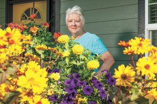 Rusty Rae/News-Register##Nancy Schick, a retired educator, enjoys working with plants in pots and in the ground in her garden. Each morning, she checks to see what’s changed overnight, such as which plant has started blooming. Her efforts led to her winning the August Yard of the Month award from the McMinnville Garden Club.