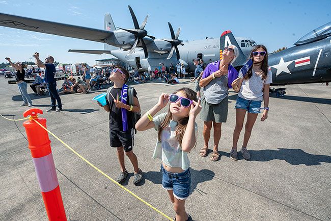 Rachel Thompson/News-Register##Among the hundreds of people taking in the Oregon International Air Show at McMinnville Airport Saturday are Sophie Bechtel of Salem and her grandchildren, Carson Kamaka, 8, left, Sadie Kamaka, 5, and Makaia Kamaka, 11. This was the youngsters’ first time at the air show, where Thunderbirds — in one dramatic formation shown below — and other aircraft performed coordinated flyovers of up to six planes at a time, in what is a late-summer tradition in McMinnville.