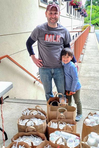 Submitted photo##David Gold is accompanied by his young son as he drops off boxes of plastic knives, forks and spoons for recycling through The Plastic Project in McMinnville. The youngster helped spearhead collection of the plastic cutlery at his Portland elementary school, ensuring it didn’t end up in a landfill.