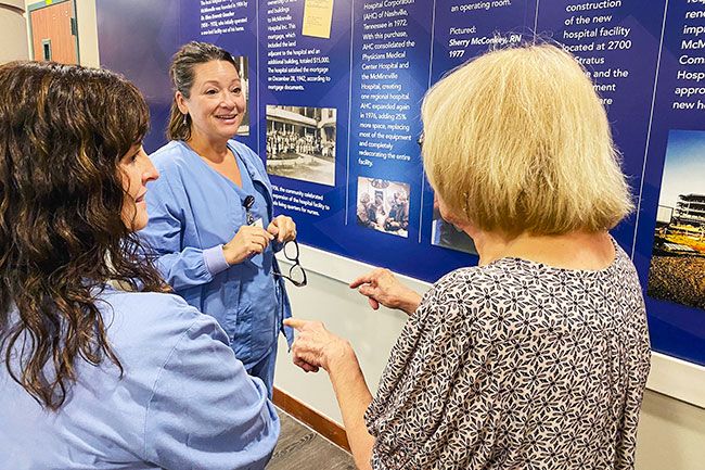 Starla Pointer/News-Register## Traci Millsap, RN, left, and Kari Lantz, surgical tech in labor and delivery, talk with Sharon Scoltock, right, at the dedication of Willamette Valley Medical Center’s new history wall. Scoltock was the hospital’s first director of obstetrics.