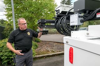 Rusty Rae/News-Register##McMinnville Police Chief Matt Scales points out the camera apparatus on the department’s new Commander 3400 mobile surveillance trailer. Scales called the equipment a force multiplier that will allow for coverage of large events with fewer officers deployed in the crowd.