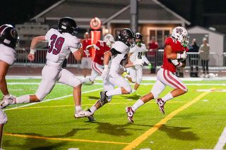 Rachel Thompson/News-Register file photo##McMinnville’s Jace Matlack escapes from several Glencoe defenders. Matlack had a pair of catches against West Salem.