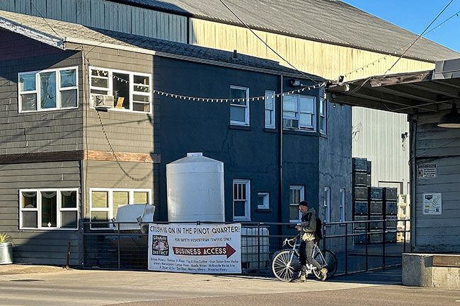 Kirby Neumann-Rea/News-Register##The short alley off Fifth Street leading to “Pinot Square” is pedestrian-only during crush each fall.