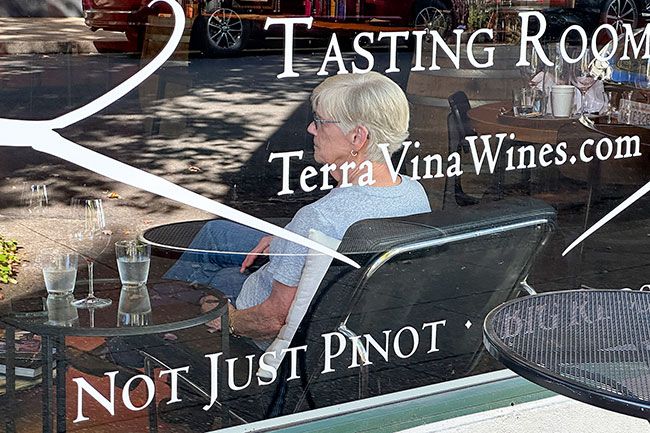 Kirby Neumann-Rea/News-Register##Window at Terra Vina on Third Street reminds wine drinkers that, even in McMinnville, reds do vary.