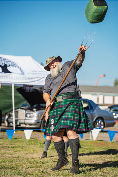 Rachel Thompson/News-Register##Scottish games Titan Tony Shouldis of McMinnville tosses the sheaf in Scottish games competition Sunday at the McMinnville Scottish Festival at Yamhill County Fairgrounds.