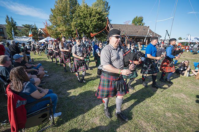 Rachel Thompson/News-Register##Mass band circles the field in the main event area at the fairgrounds Sunday, the daily opening ceremony for the McMinnville Scottish Festival. Clans and other Scottish heritage groups, some represented by drum and pipe corps, carried the tartans and banners, all part of the two-day pageant of Scottish games, music and culture, food and drink, British automobiles and more. The McMinnville Celtic Alliance sponsors the annual festival.